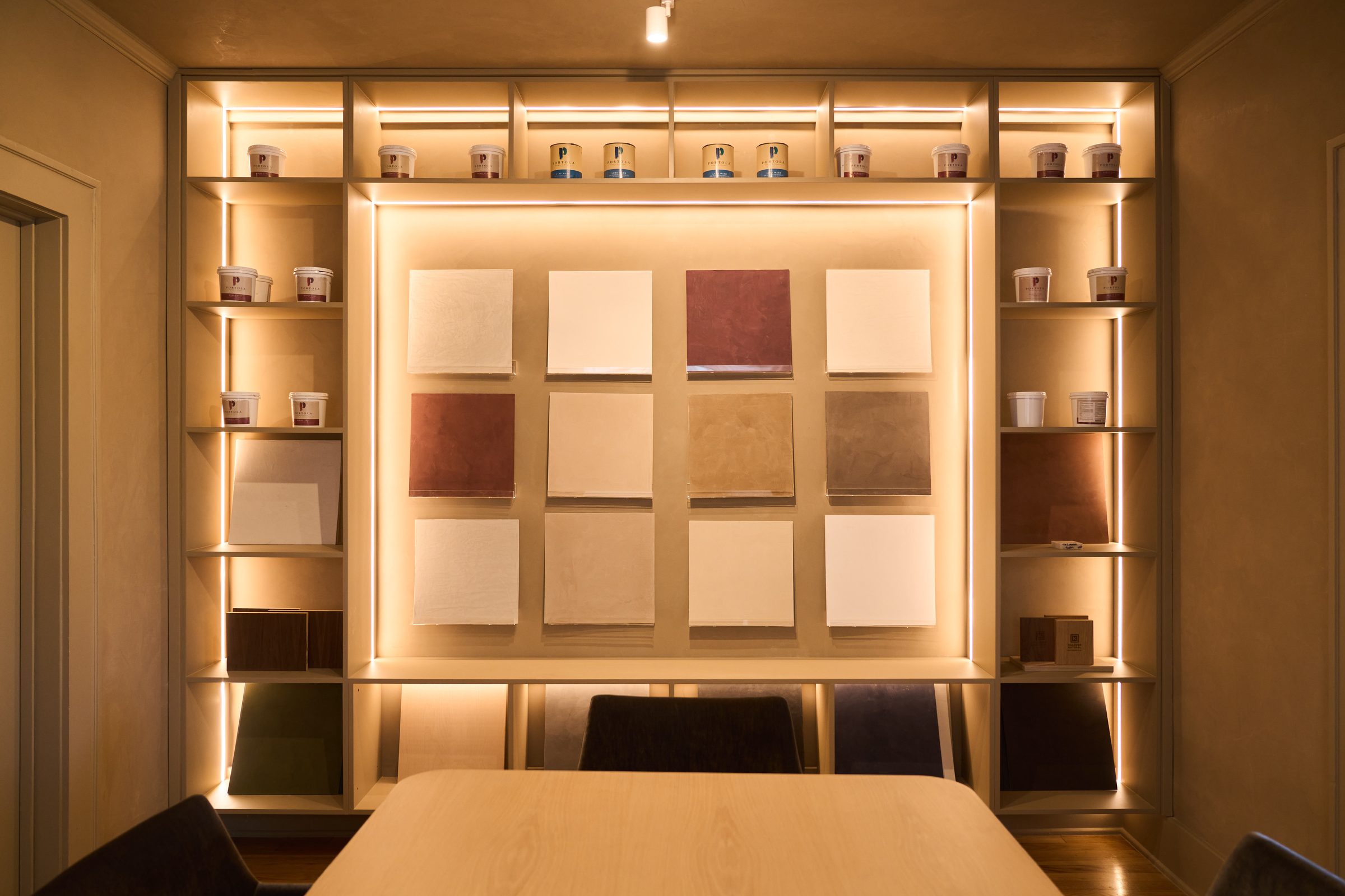 Koncept Plaster showroom in Austin, Texas, displaying handcrafted lime plaster sample panels under warm light